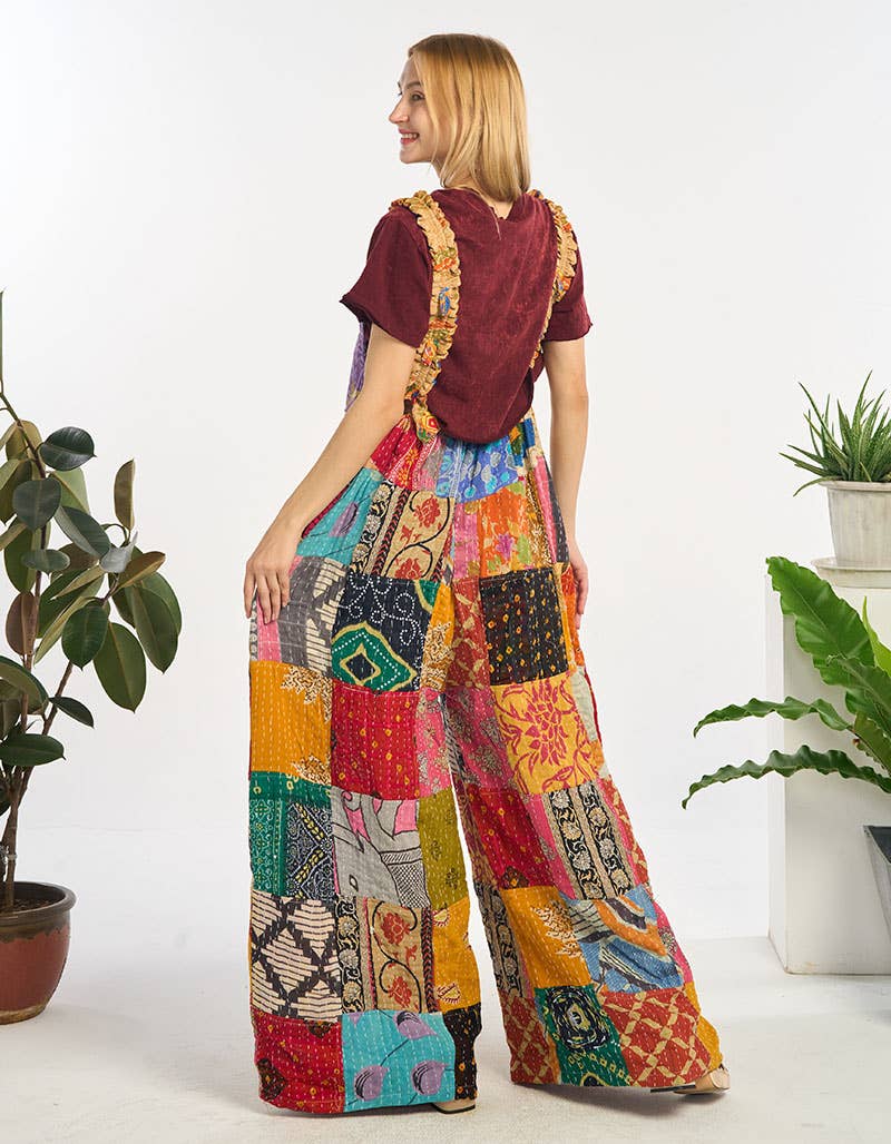 Woman wearing a colorful patchwork outfit with a white background