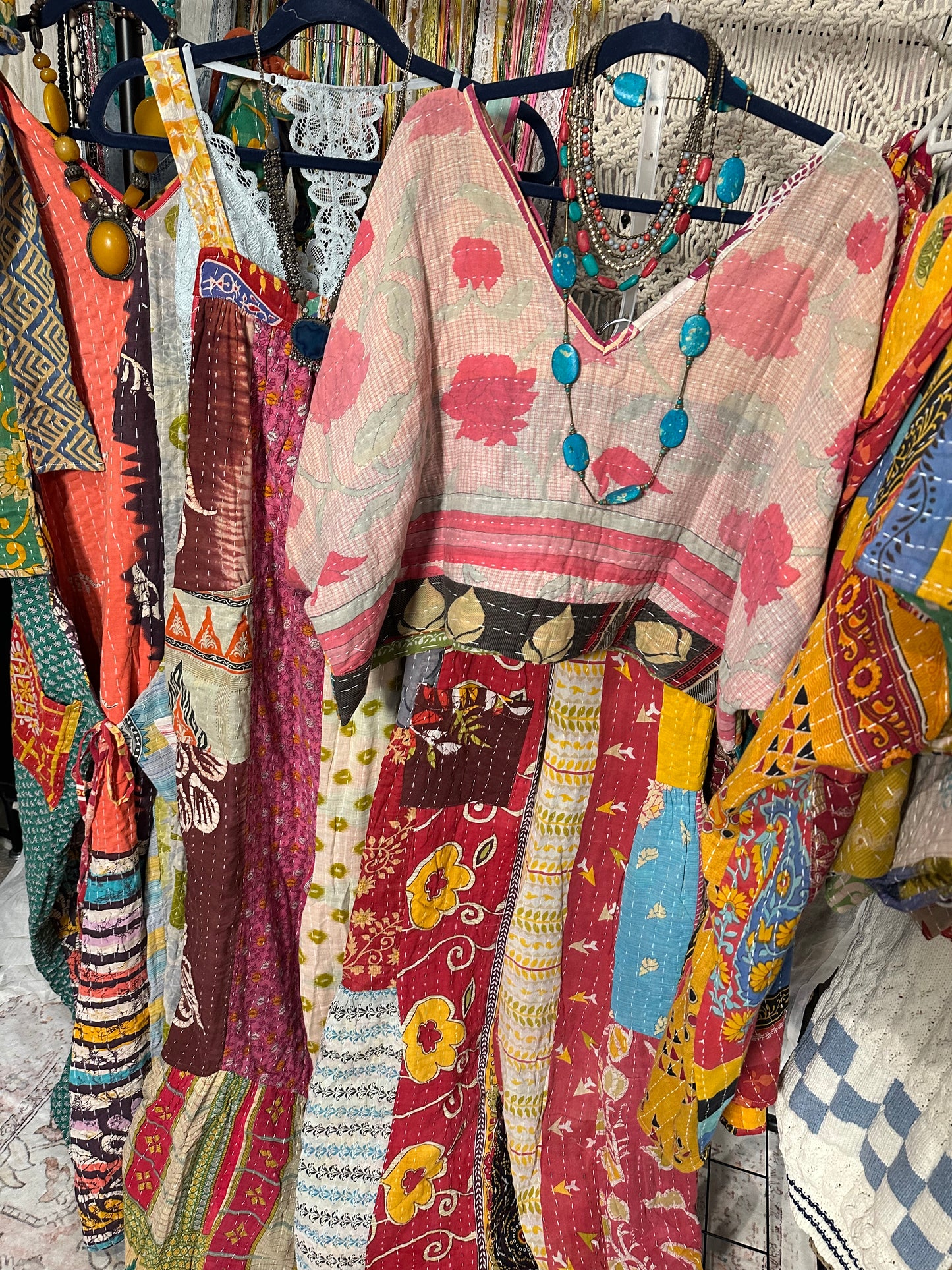 Colorful fabric with intricate patterns and designs on a hanger.